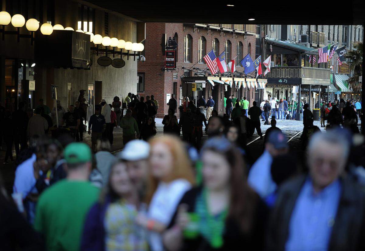 Crowds of revelers celebrate a previous St. Patrick’s Day along historic River Street in Savannah.
