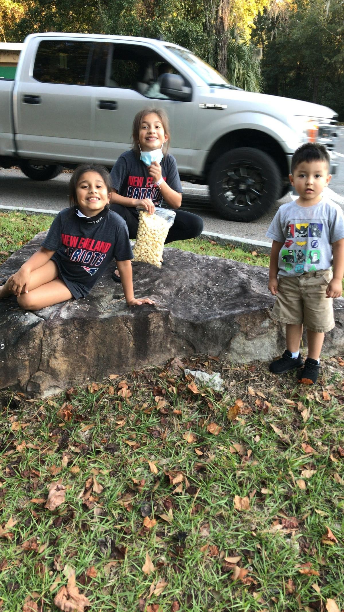 Dania Rodriguez-Beas (left), Lucy Rodriguez-Beas and Gerardo Vera-Beas play outside on a recent spring day.