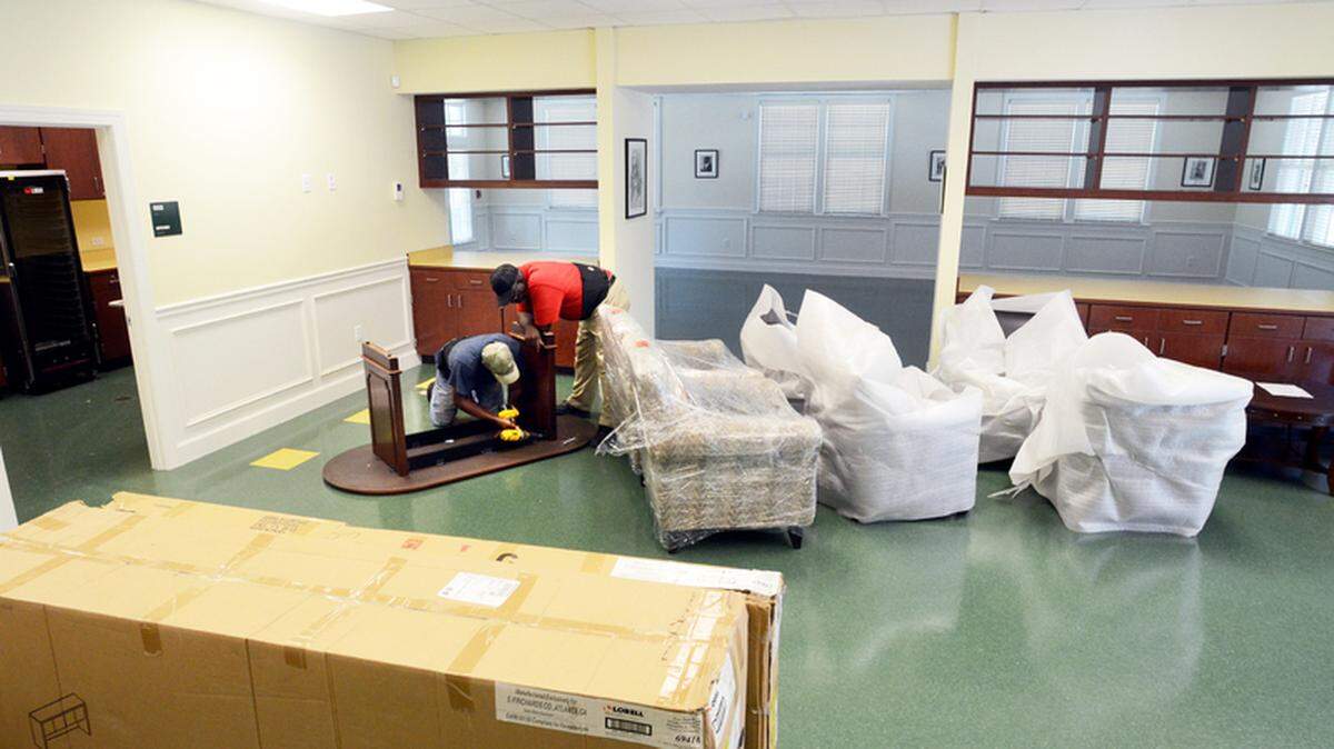 George White and Herbert Robinson assemble a desk  in the senior center section of the Beaufort-Jasper-Hampton  Comprehensive Health Services building on St. Helena Island on Thursday.  The new building will be dedicated on Sunday.