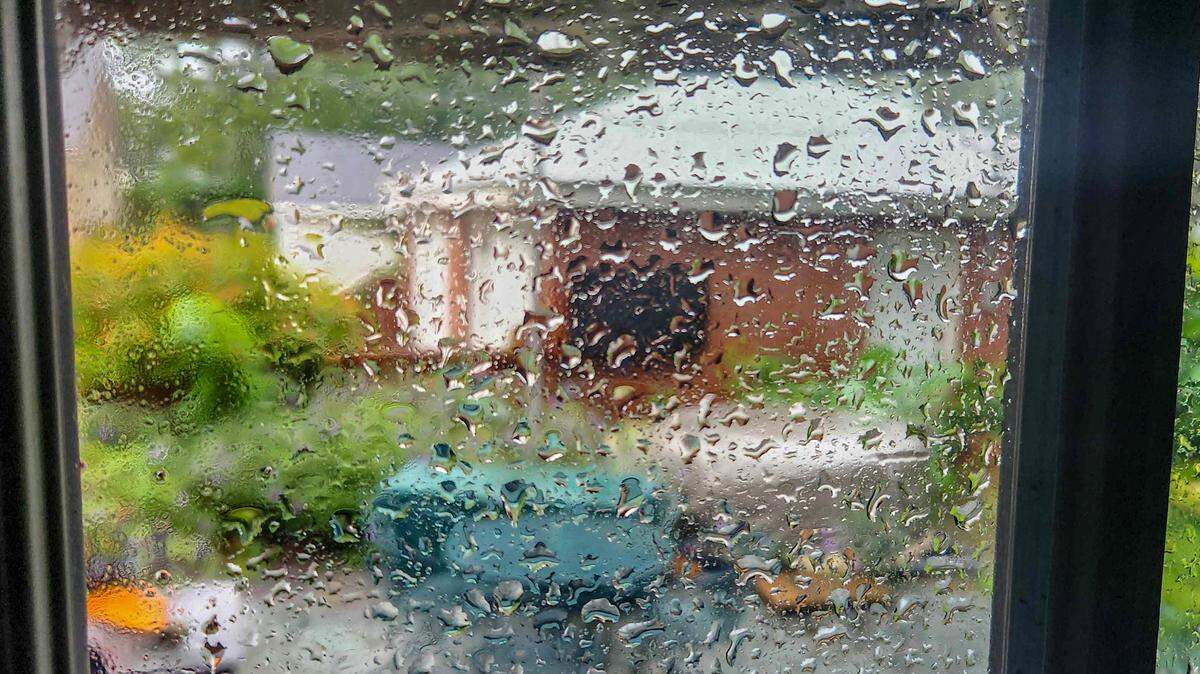 Inclement weather produces rain droplets on a window.
