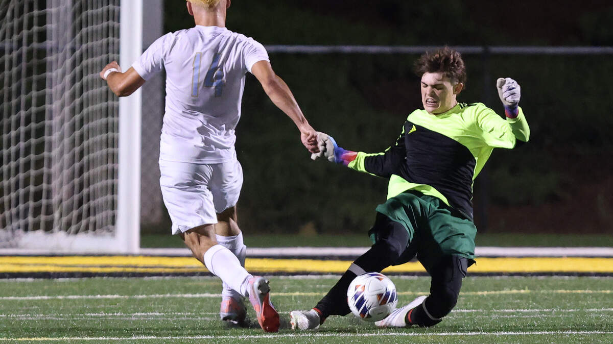 Nigel Bell (0) of Beaufort makes a save as Kenneth Walton-Flores (14) of Daniel pushes to the goal during the SCHSL Class 3A Boys State Soccer Championship between Beaufort and Daniel at Irmo High School on Saturday, May 13, 2023.
