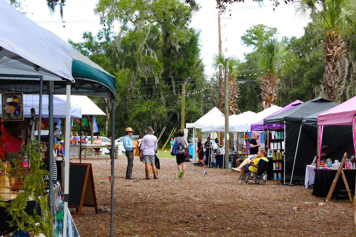Vendors in tents sell artwork, jewelry water bottles, coffee, baked goods and more at Live Oaks Park in Port Royal Plaza for the Lowcountry Pride Celebration.