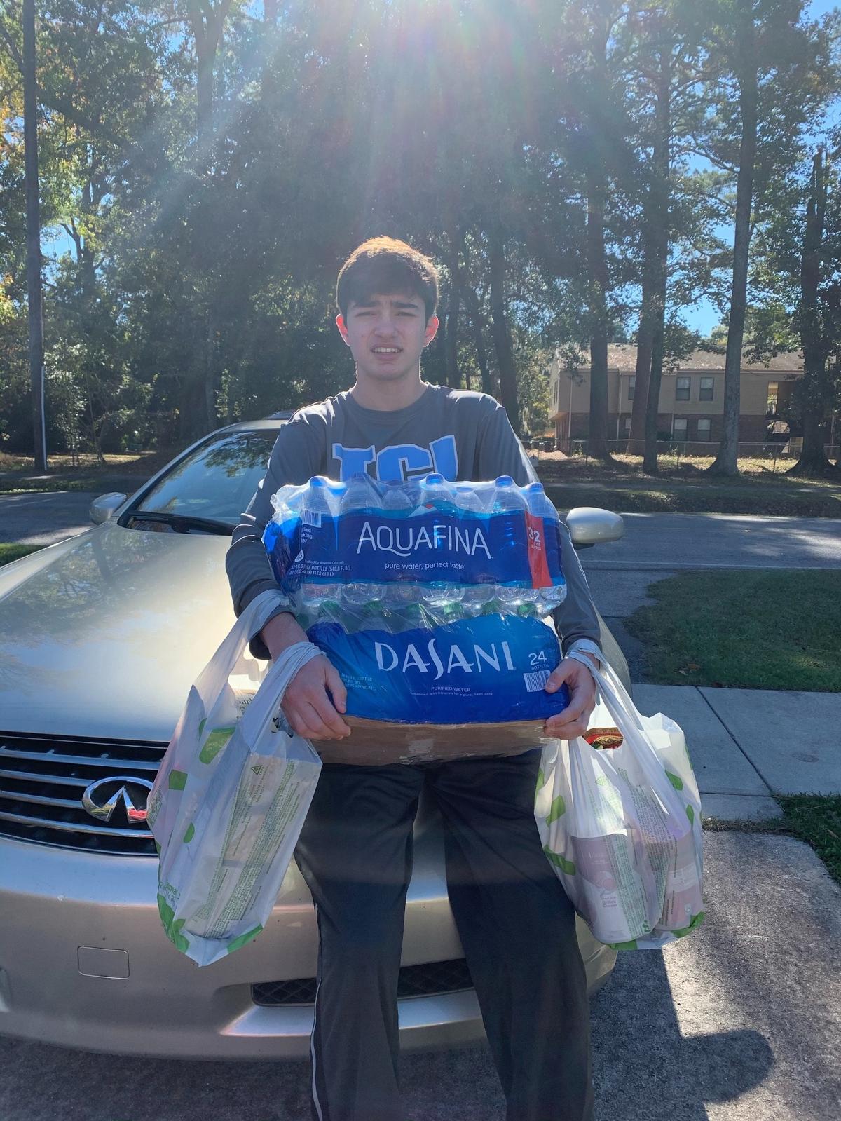 Quade Matthews picks up donations for HELP of Beaufort. He and his brother have launched an effort to stock the charity’s shelves by Dec. 21.