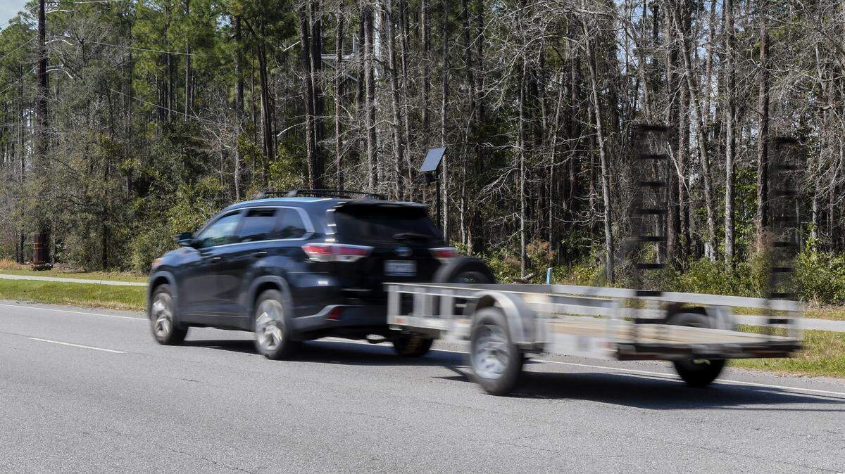 Traffic moves along Okatie Highway in greater Bluffton on March 14, 2025, as a Flock camera can be seen mounted on a pole for southbound traffic near the Bluffton Parkway intersection. The automatic license plate readers cameras, mounted throughout Bluffton and Beaufort County, record license plate numbers, a vehicle’s make and model and the days and times a vehicle has traveled past the device.