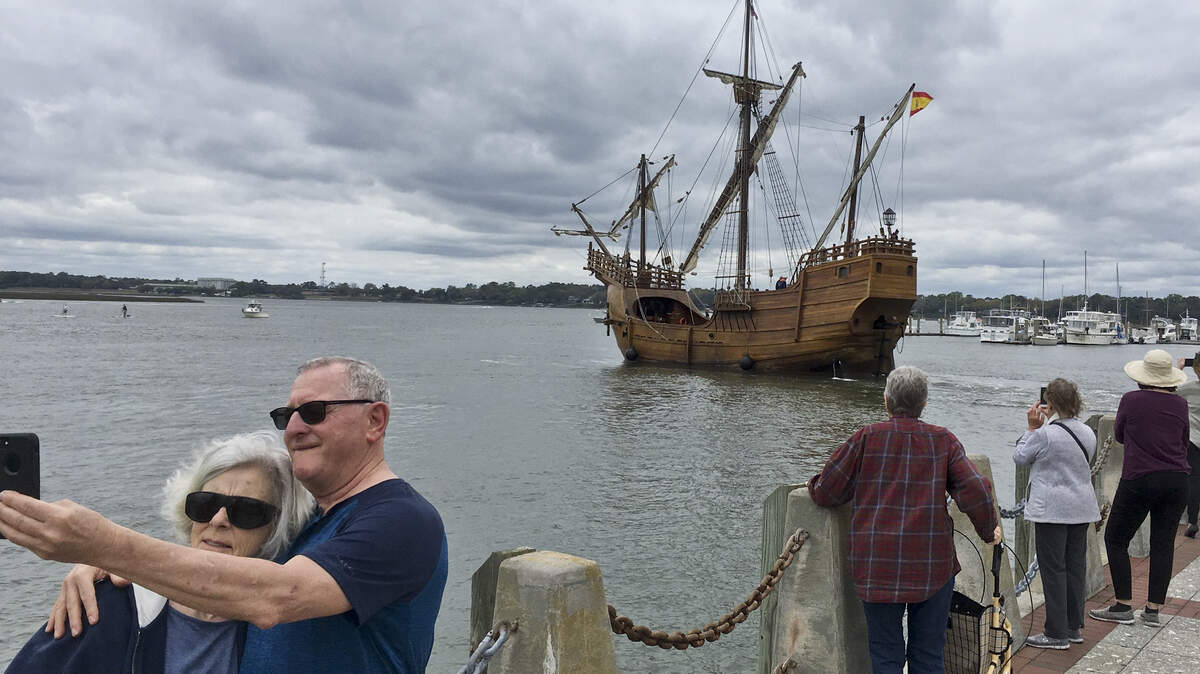 An unidentified couple take a selfie as the Nao Santa Maria, a model of the ship captained by explorer Christopher Columbus in 1492, arrives Friday iafternoon at Henry C. Chambers Waterfront Park. Tours of the ship will be available from April 6-14 and visitors can buy tickets online or pay on site to board.