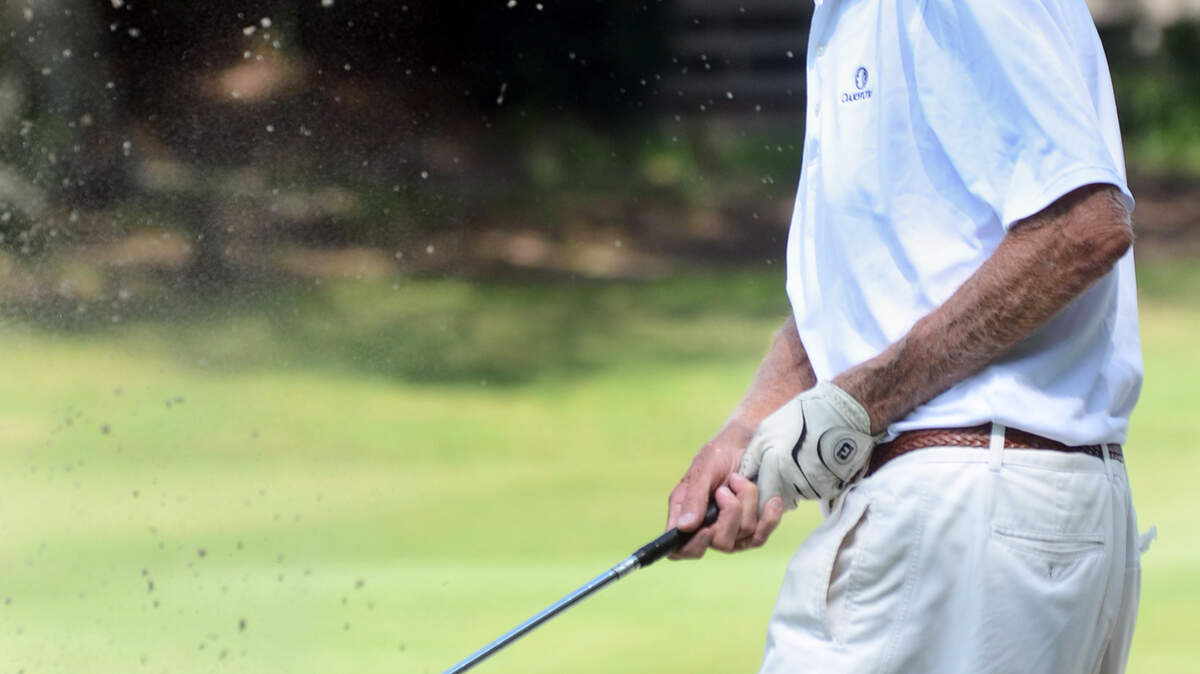 Leo Luken watches his bunker blast on No. 18 of the Robert Trent Jones Golf Course in Palmetto Dunes on Saturday. The 95-year-old was attempting to shoot lower than his age for the 1,000th time. He missed on Saturday, but did reach the mark on Tuesday.
