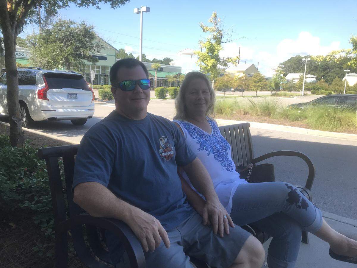 Steve and Ruth Boyer, of West Chester, Penn., sit on a bench at Tanger 1 Outlets, which was closed Tuesday, Sept. 11, 2018, after now-lifted evacuation orders for Beaufort County, ahead of Hurricane Florence.