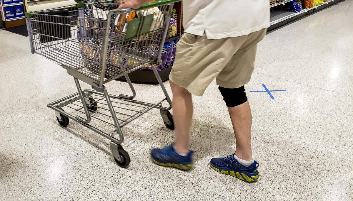 Aisles at Publix in Bluffton Commons were modified into one-ways for shoppers as this shopper, on Wednesday, April 8, 2020, pushes his cart past an aisle marked with an “x,” signifying no entry. On Monday, S.C. Governor Henry McMaster placed an executive order that essential businesses must limit the number of customers based on the square footage of their facility or 20% of the occupancy, whichever is less, in hopes of stemming the spread of the coronavirus.
