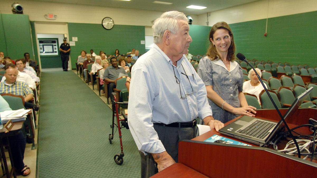 Jerry Reeves, president of the Bluffton Historical Preservation Society, and Heyward House executive director Maureen Richards, dressed in antebellum garb, address Bluffton Town Council on Tuesday about a proposed annual observance of the  burning of Bluffton during the Civil War. As part of their presentation, Richards handed Mayor Lisa Sulka a copy of a letter written by a witness to the historic burning.