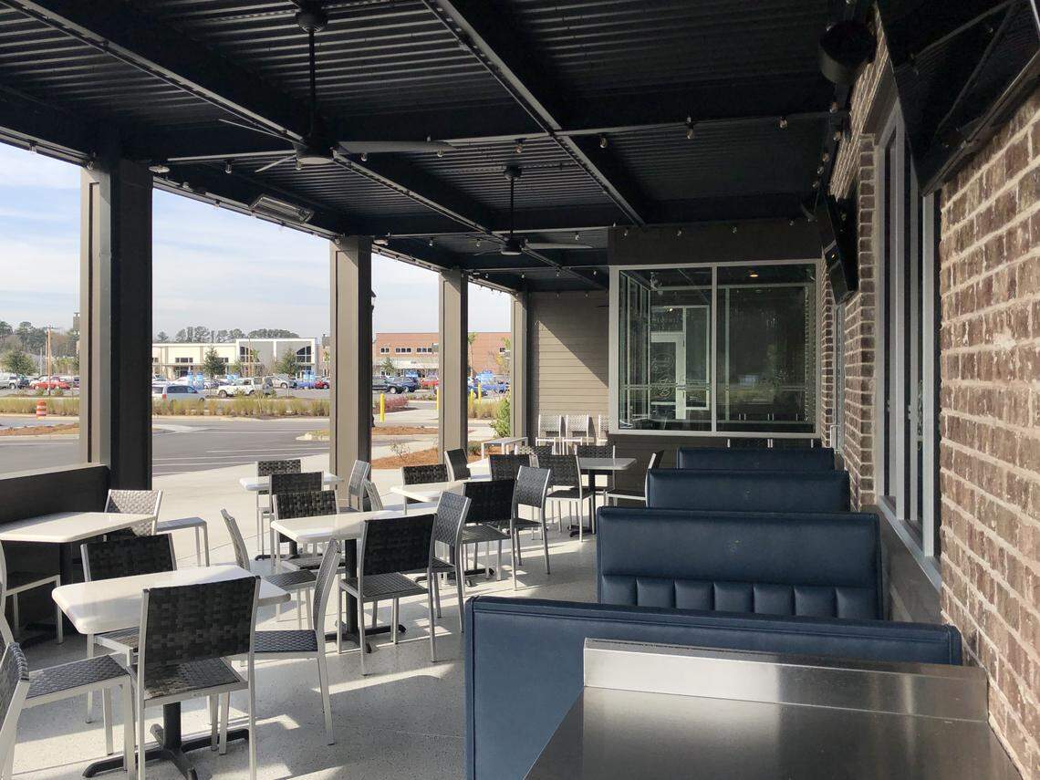 The front of Frankie Bones in Bluffton has a patio seating area with televisions.