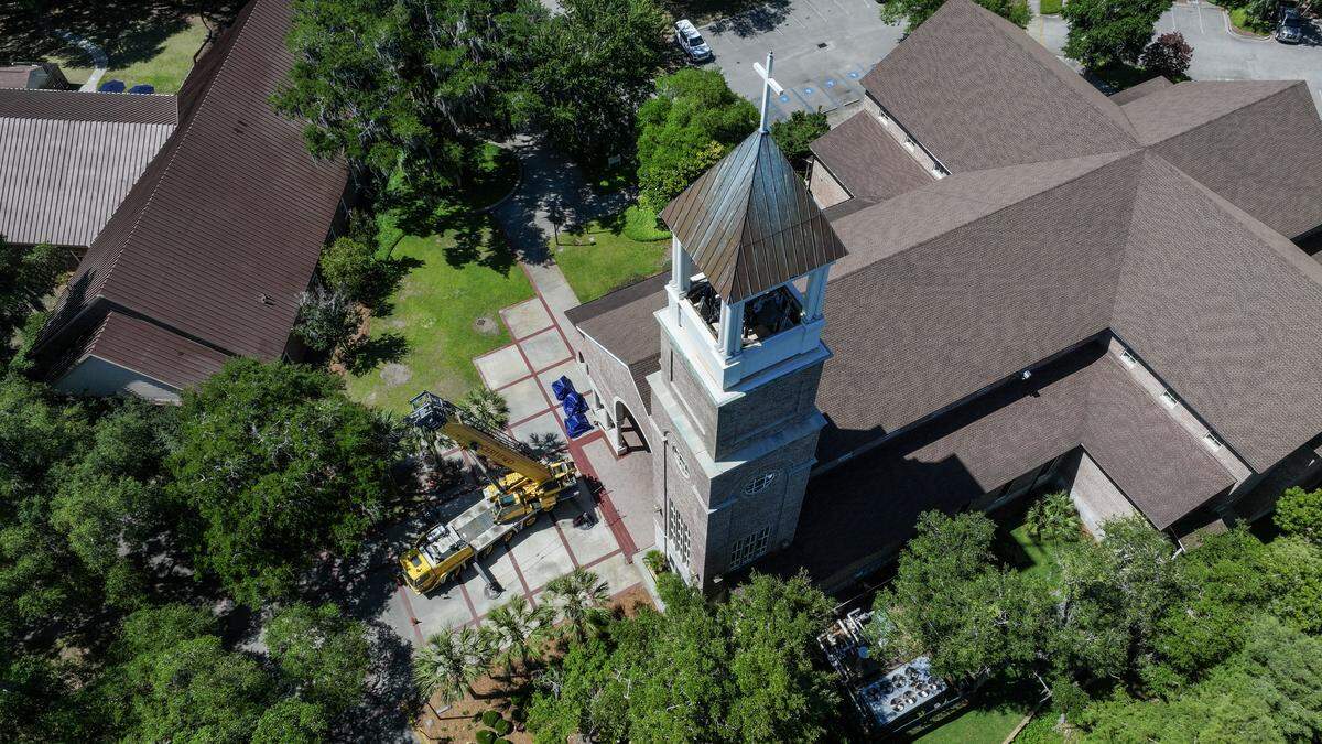 A 165-ton crane sits at the front doors to St. Peters Catholic Church on May 19, 2026, to raise the final three bells to its steeple on Lady’s Island.