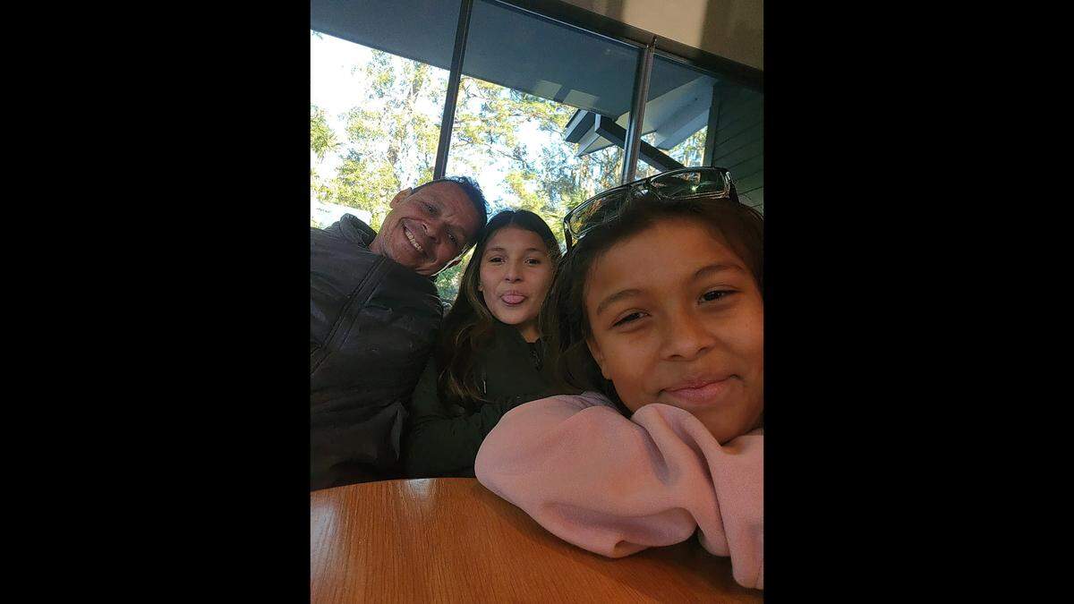Hilton Head Island man Henry Boynton (left) poses for a picture with two of his daughters. The “devoted father” died in a traffic accident the week before Christmas, leaving behind his partner and four children.