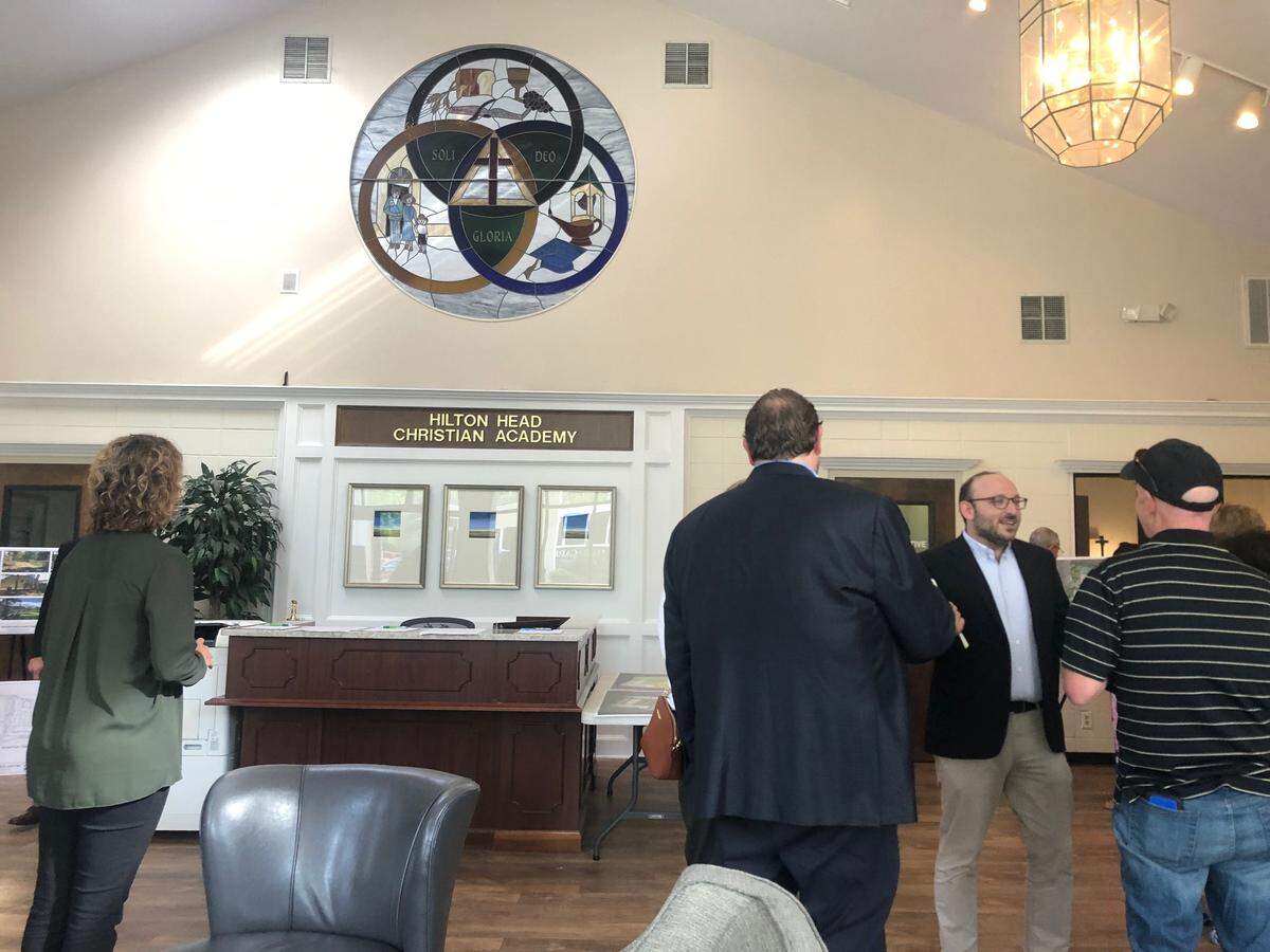 Representatives from Spandrel Development Partners and Hilton Head Christian Academy speak with residents of Old Woodlands on Thursday, May 2. The open house-style meeting was to discuss Spandrel’s impending application for rezoning of the campus to build apartments.