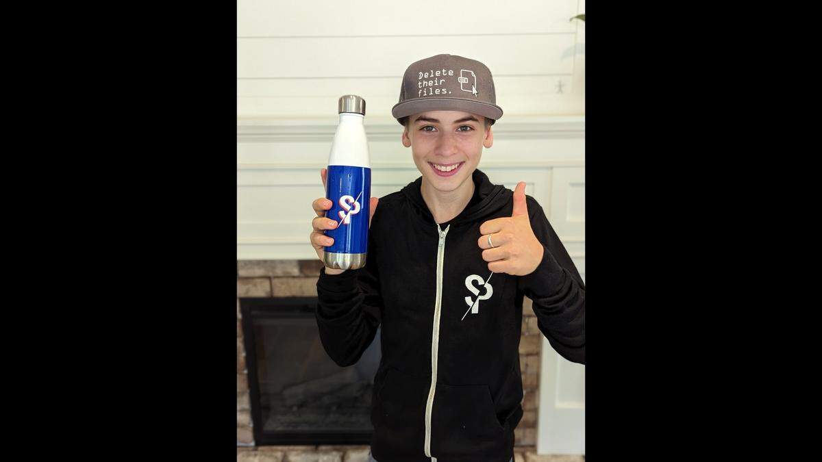 Renner Taylor, 13, of Beaufort, proudly shows off merchandise sent from his favorite YouTube channel, Scammer Payback, after they heard about his efforts to stop scammers from targeting an elderly man in January.