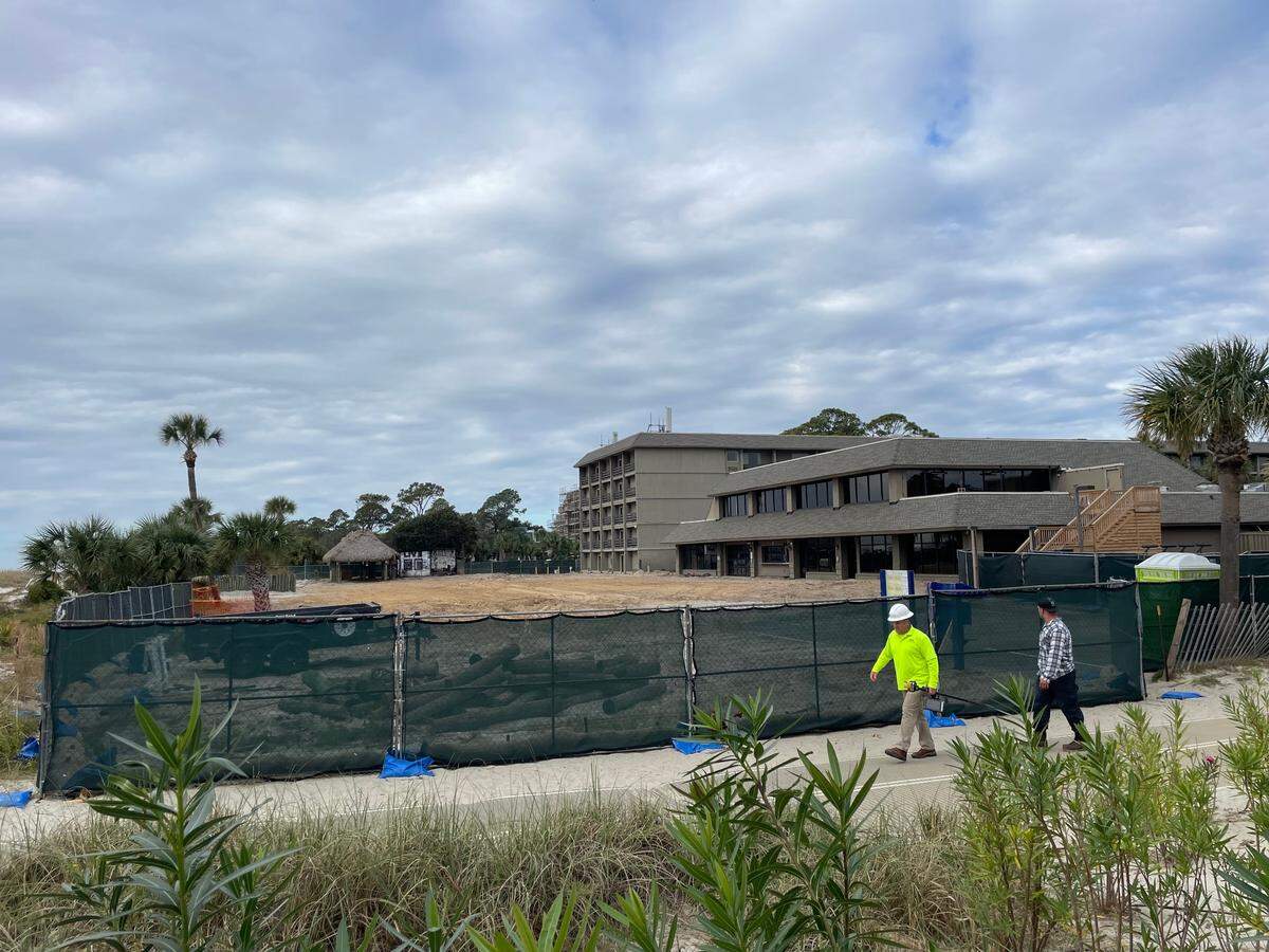 A construction worker walks past the now-demolished Beach House Hilton Head Island back area on Friday, Nov. 3, 2023.