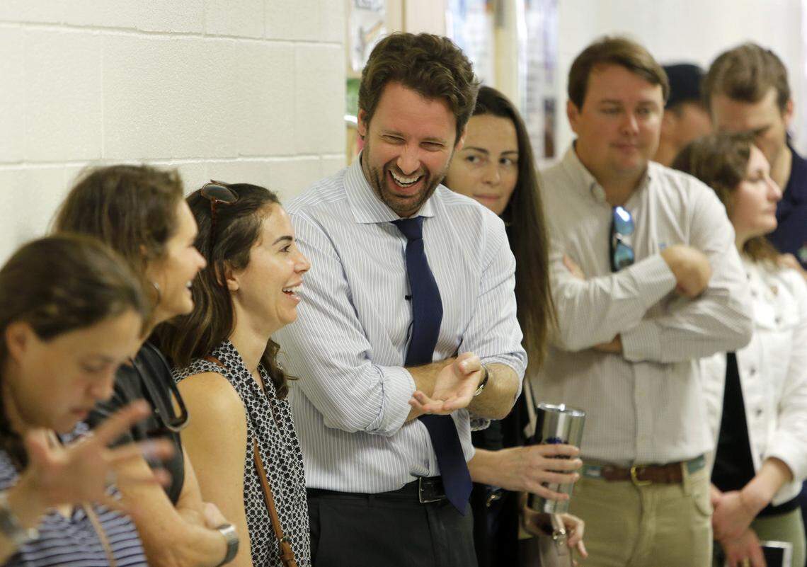 Joe Cunningham, center, Democrat recently elected to congress, waits in line to vote at St. Andrews School of Math and Science in Charleston, S.C., Tuesday, November, 6, 2018.