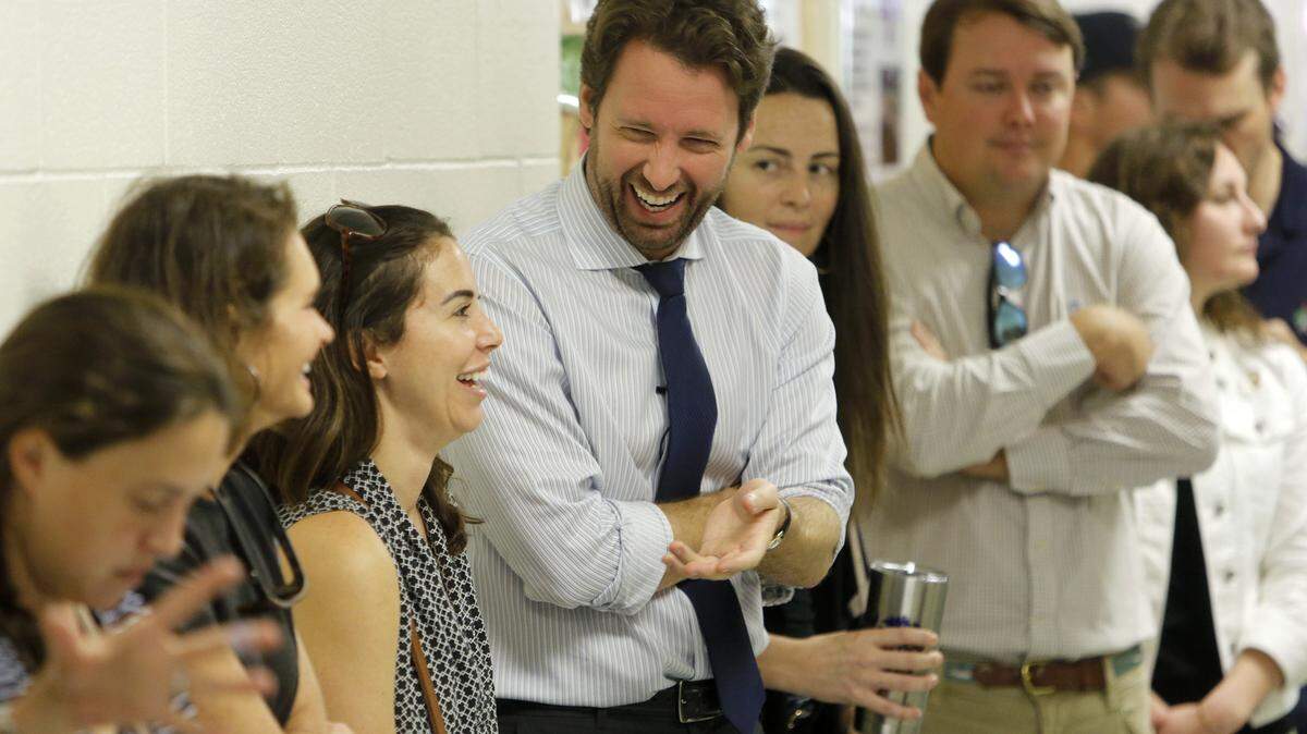 Joe Cunningham, center, Democrat recently elected to congress, waits in line to vote at St. Andrews School of Math and Science in Charleston, S.C., Tuesday, November, 6, 2018.
