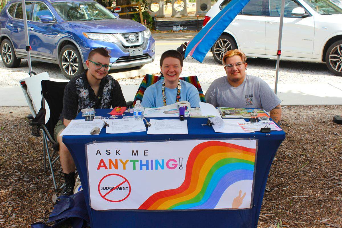 An “ask me anything” table offers a judgement-free zone for people with questions about the LGBTQ community to seek answers. When Sam Baggett (center, he/they) came out to his parents, he was the only queer person his family members knew. “All the questions, bigotry and the stereotypes ... on top me having to figure out how I was going to be in like, myself, that was a lot,” Baggett said. Booths like these “ease the burden” on individuals who come out to their families by offering a space for confused family members who want to be supportive to ask uncomfortable questions.