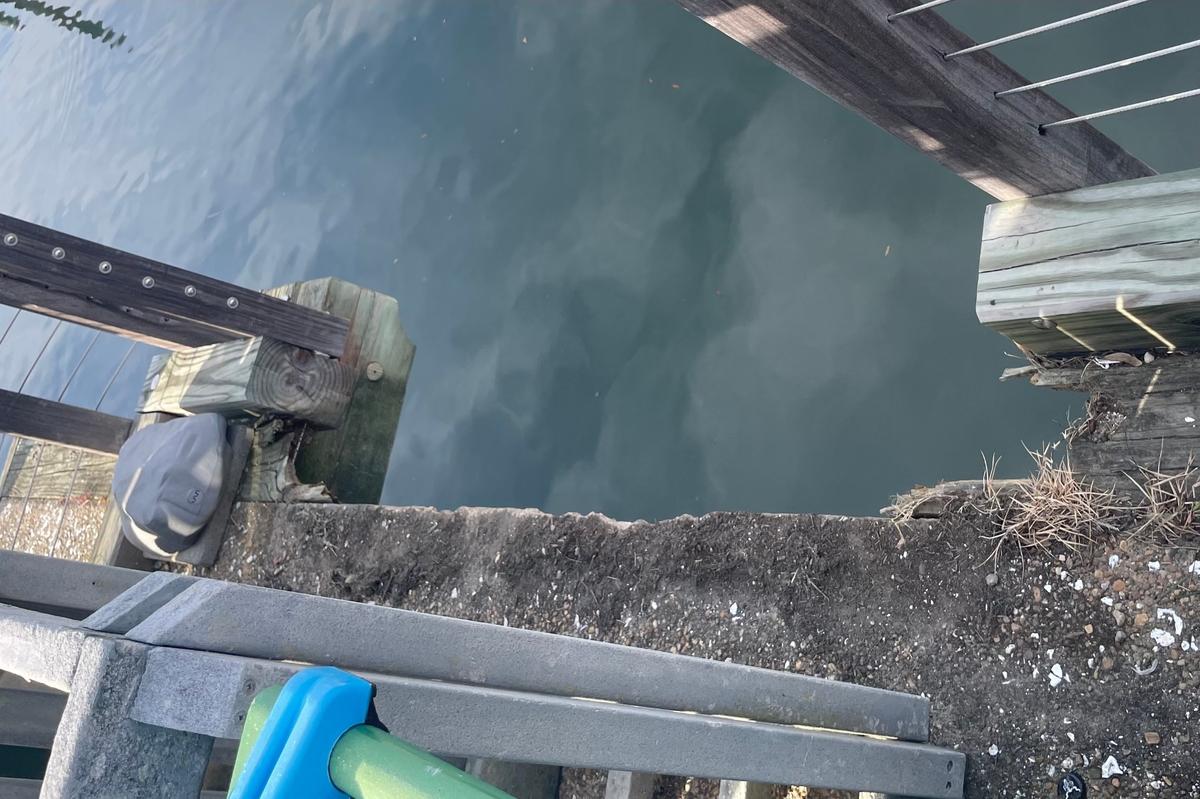The gangway ripped away a chunk of the wood surrounding the concete walkway, which appears to be in a deteriorating condition. Photo taken March 14, 2020.