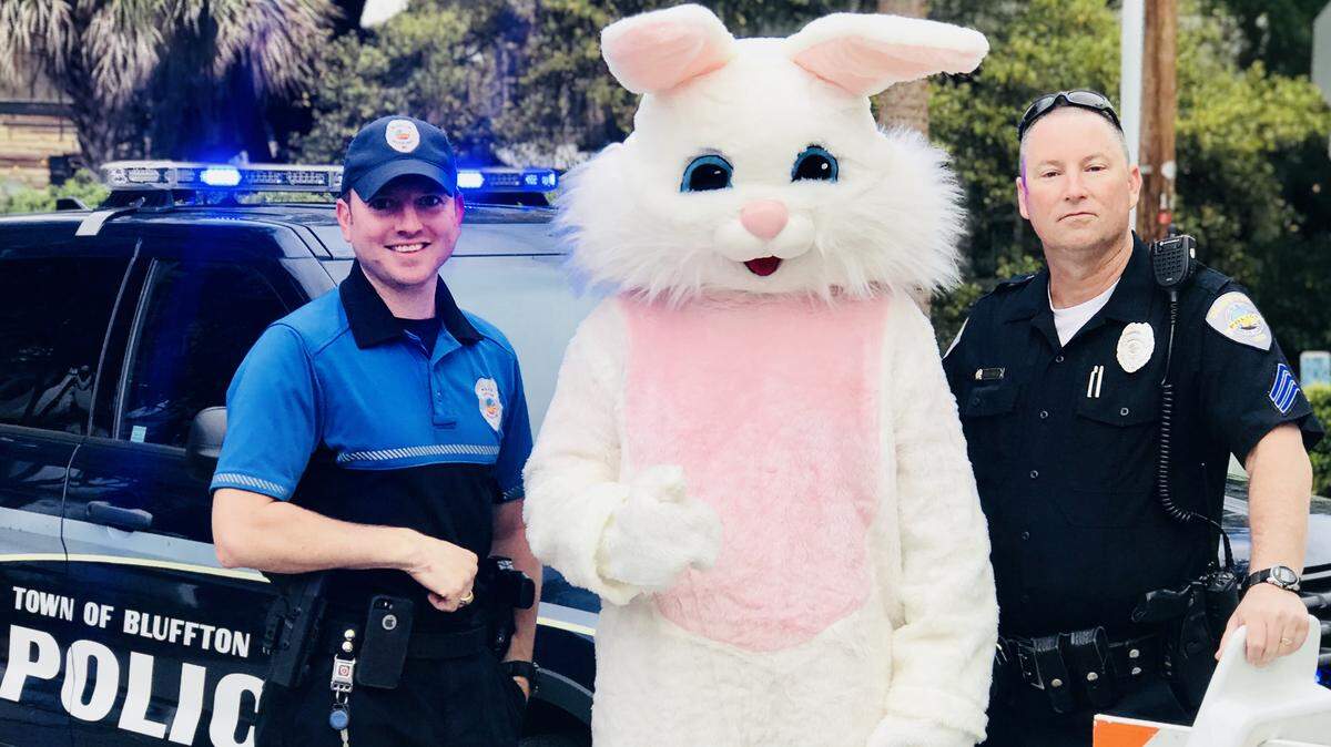 Two of Bluffton's finest share a moment with the Easter Bunny on Calhoun Street during the children's parade.