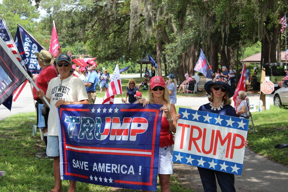 Pro Trump-demonstrators hold up signs by the side of U.S. 278 on June 14, 2025. The Coastal Conservative Alliance puts on small demonstrations like these every few months, according to Lynn Fontaine.