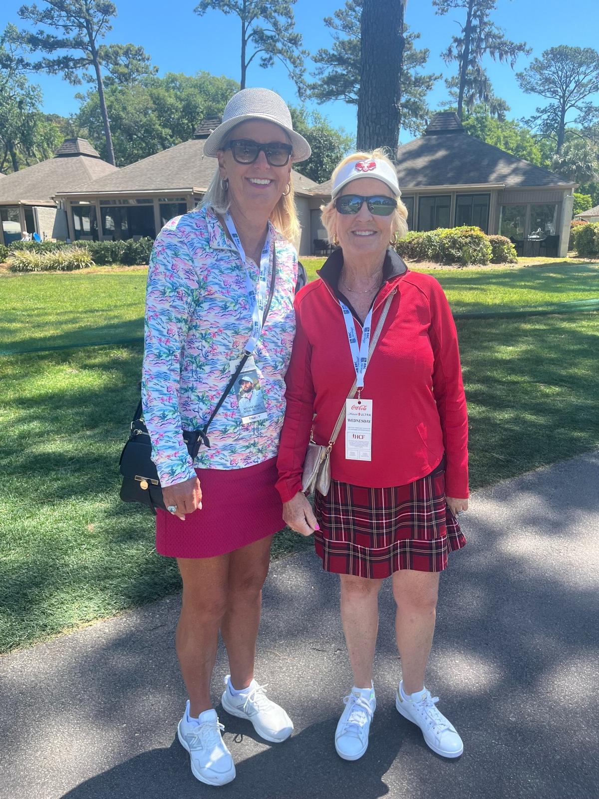 Tina Moore (left) in her spring pink and floral patterns and Carolyn Paskert (right) in her red and plaid ensemble