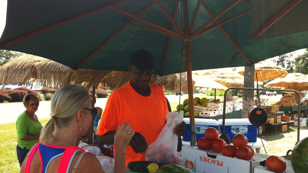 Wesley Campbell, who has been peddling vegetables since he was 5 years old, says he will remain in business on U.S. 278 despite the encroaching construction on the Bluffton Parkway flyover.