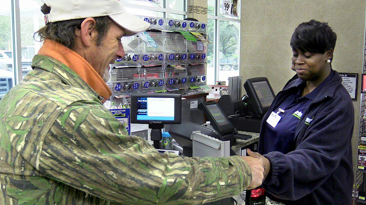 Sakitha Williams, an employee at Parker's gas station at Jennifer and Buck Island roads in Bluffton, sells a Powerball ticket Jan. 6 to a customer who declined to give his full name. Tickets were selling at a rapid pace as many were looking to cash in on a jackpot estimated to be the biggest in nearly a year. Last February, a $564 million Powerball jackpot was shared by winners in North Carolina, Texas and Puerto Rico.