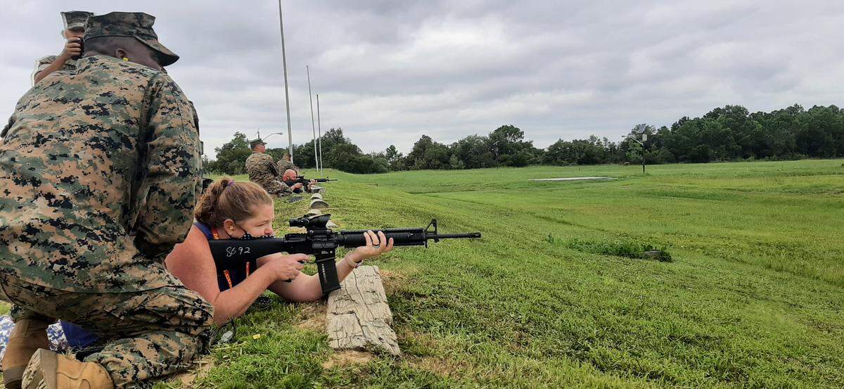 Alabama teacher Heather Hendrix fires an M16 under the direction of Sgt. Trevon Mays at Parris Island.