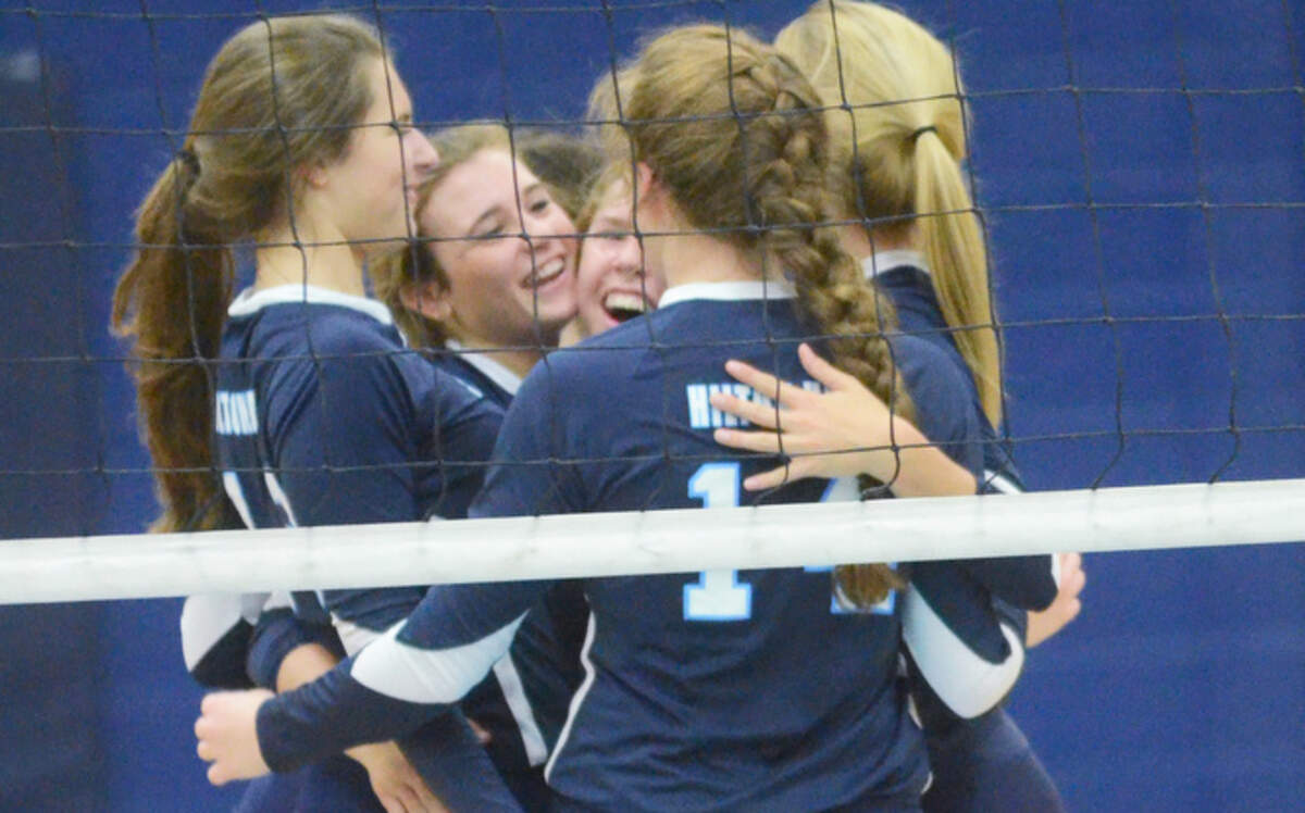 Seahawk players celebrate a winning point as Hilton Head Island High School takes on Aiken in the Class 3-A volleyball playoffs on Thursday.