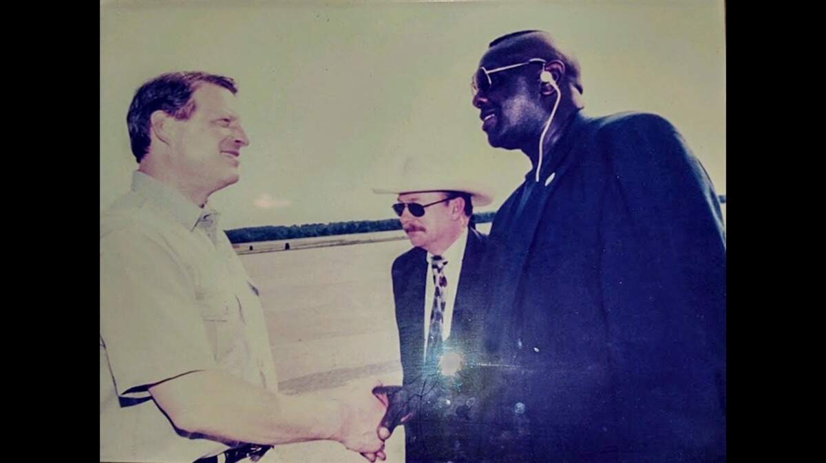 Bobby Jenkins meeting Vice President Al Gore. The is a photo of a photo taken with camera flash.