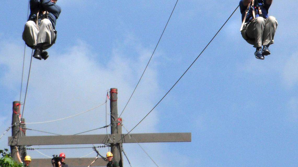 Hilton Head Island Mayor Drew Laughlin, left, and  owner Roger Freedman, take a ceremonial zip down the dual cable racing  line at the opening of Zipline Hilton Head. A Zip for Charity event is planned for May 4 to raise money for the Wexford Plantation Charitable Foundation. 