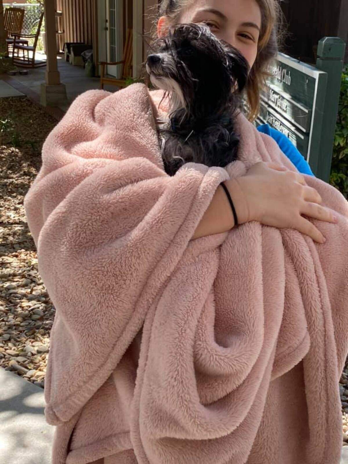 Gia King holds Coco in a blanket after she was retrieved from the Hilton Head Humane Association Sunday.