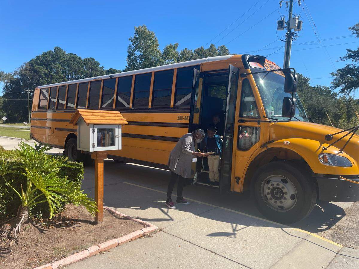 Students get off a school bus at Mt. Carmel Baptist Church.