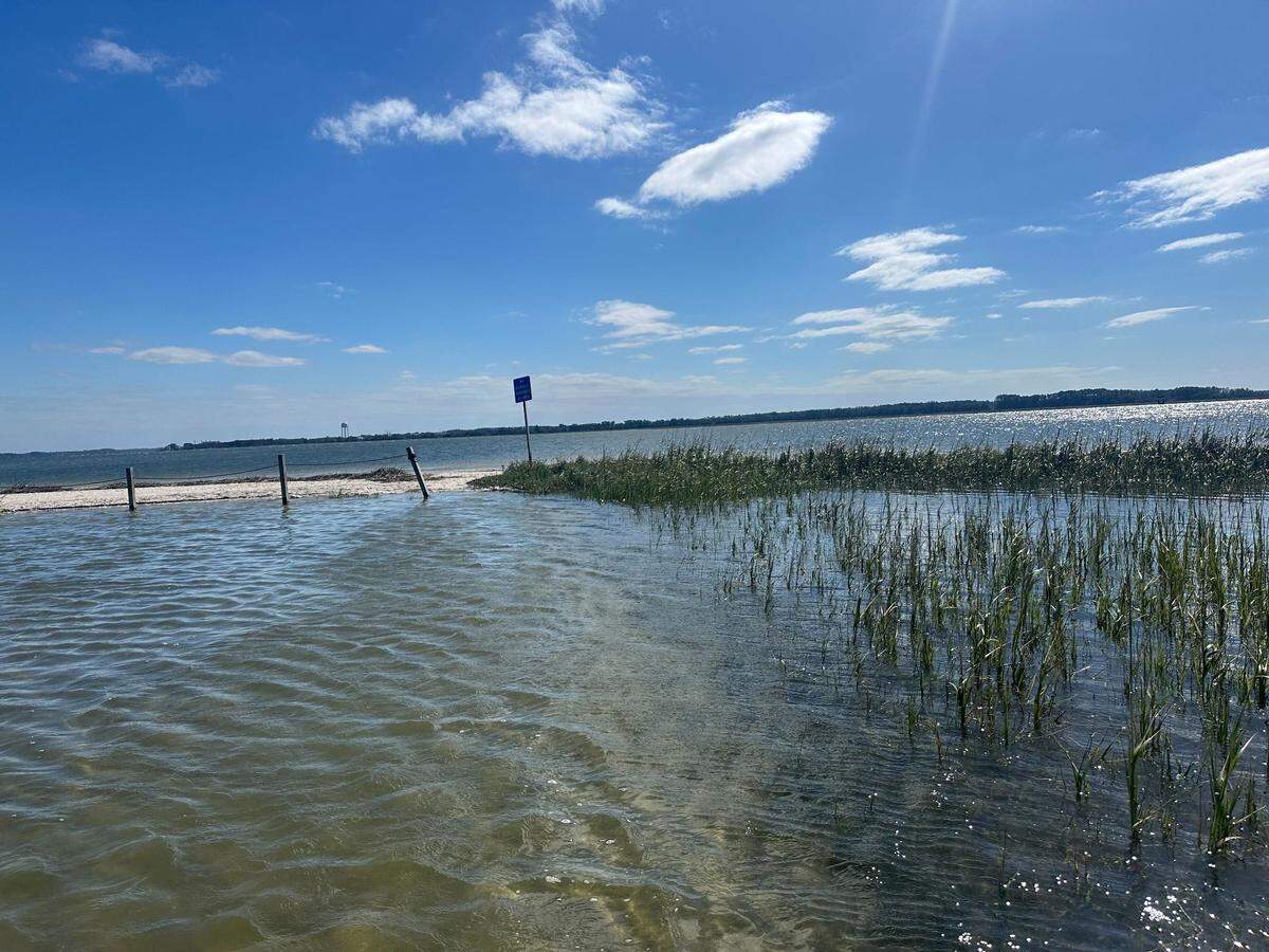On Thursday, October 10, 2024, the parking lot area of Port Royal’s Sands Beach was inundated with water nearing high tide after erosion from Helene. Visitors waded through the pools to the beach as the afternoon’s high tide threatened to bring more water into the area from Milton, which became a post-tropical cyclone as the storm moved from Florida into the Atlantic Ocean.