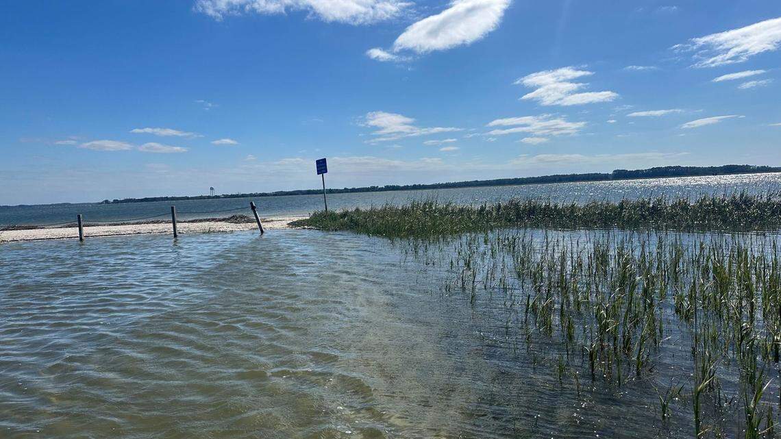 On Thursday, October 10, 2024, the former parking lot of Port Royal’s Sands Beach remained inundated with water after storm surge from Helene. Visitors waded through the pools to the beach as the afternoon’s high tide threatened to bring more water into the area from Milton, which became a post-tropical cyclone as the storm moved from Florida into the Atlantic Ocean.