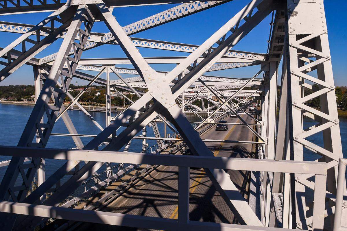 Shadows are cast against the steel girders and deck of the Richard V. Woods Memorial Bridge on Nov. 29, 2022. Photographed from the deck where the swing span bridge is controlled, the historic district of Beaufort can be seen in the background.