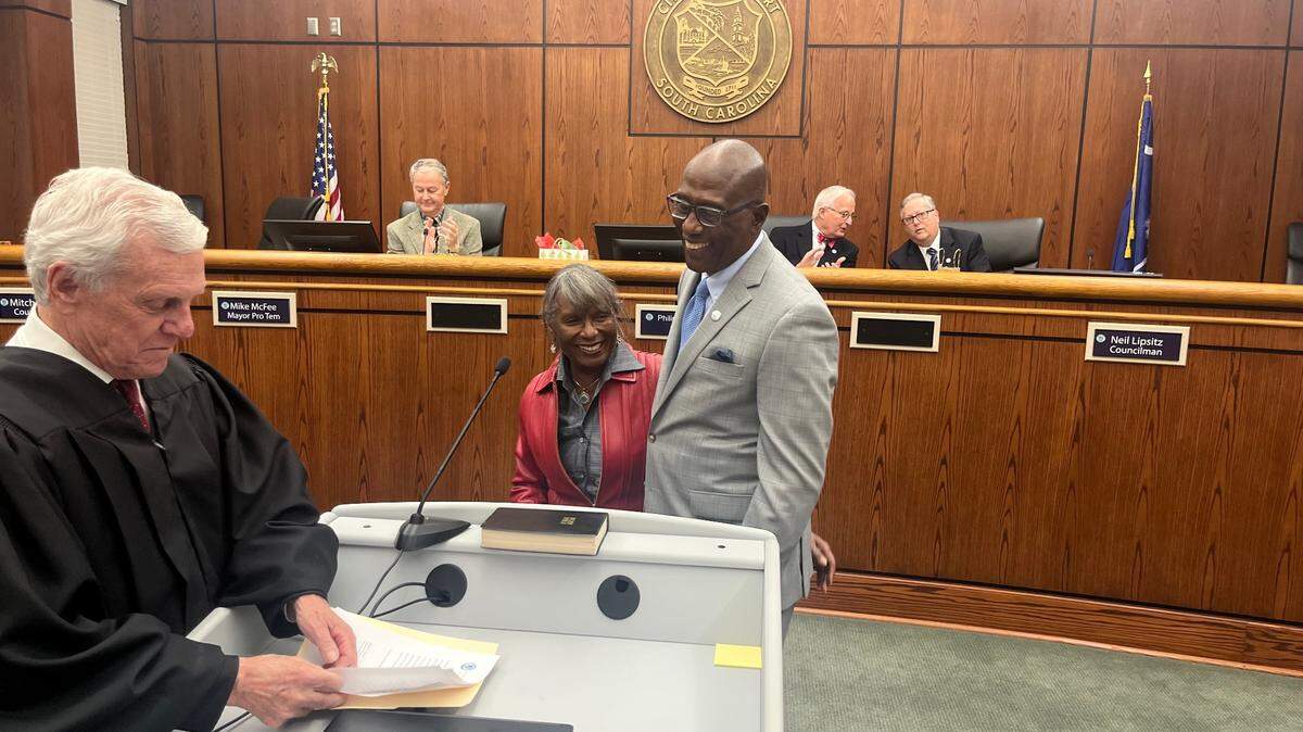 Mitch Mitchell was sworn in for a second term on the Beauforet City Council by Municipal Judge Ned Tupper Tuesday. Kelly, his wife, joined him.