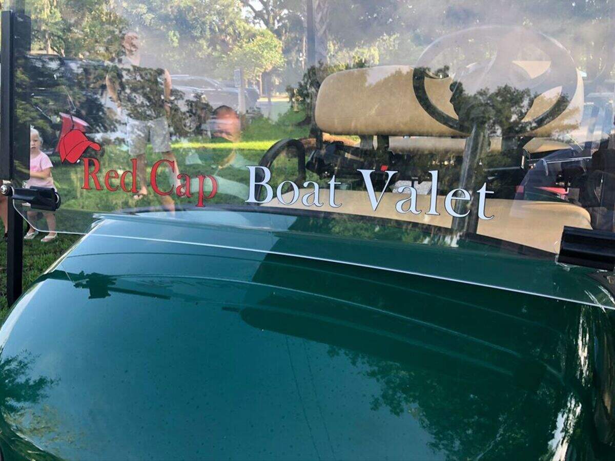 The front windshield of Jeffrey Gainey’s new golf cart pays homage to his signature red baseball cap he wears while directing boat traffic at the boat launch on the May River.