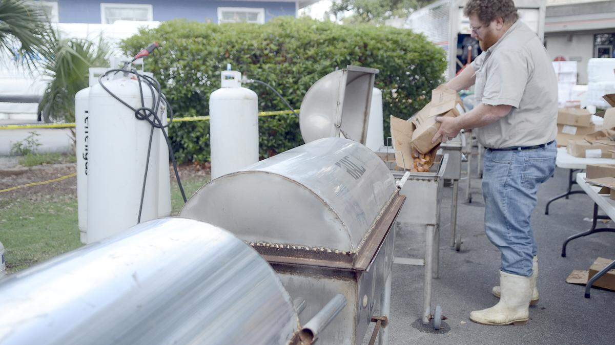 Craig Reaves, owner of Sea Eagle Market, drops sausage into the boiling water the afternoon of July 24, 2014, in preparation for the night's Lowcountry Supper during the 59th Beaufort Water Festival at Henry C. Chambers Waterfront Park in Beaufort.