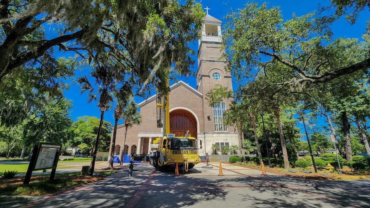 A 165-ton crane sits at the front doors to St. Peters Catholic Church on May 19, 2026, to raise the final three bells to its steeple on Lady’s Island.