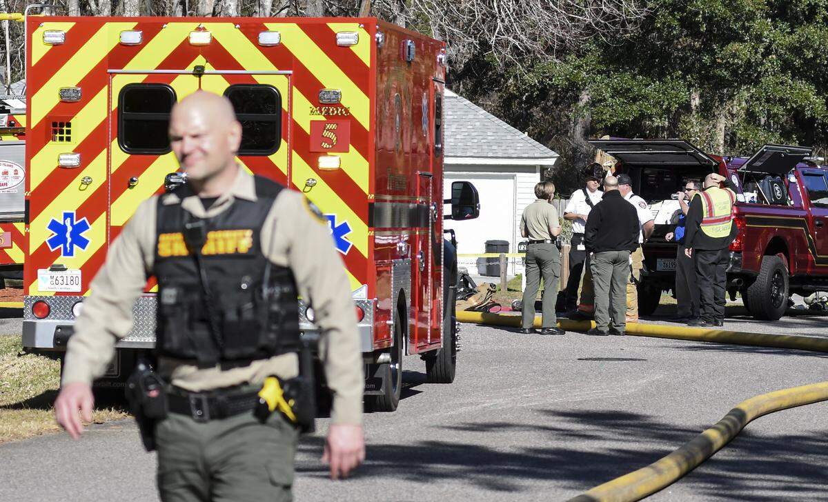 A deputy with the Beaufort County Sheriff’s Office leaves the scene of a fatal house fire on Monticello Drive in Chinaberry Ridge Wednesday afternoon on Hilton Head Island as law enforcement and officials with the Town of Hilton Head Island Fire & Rescue Division gather in the background.