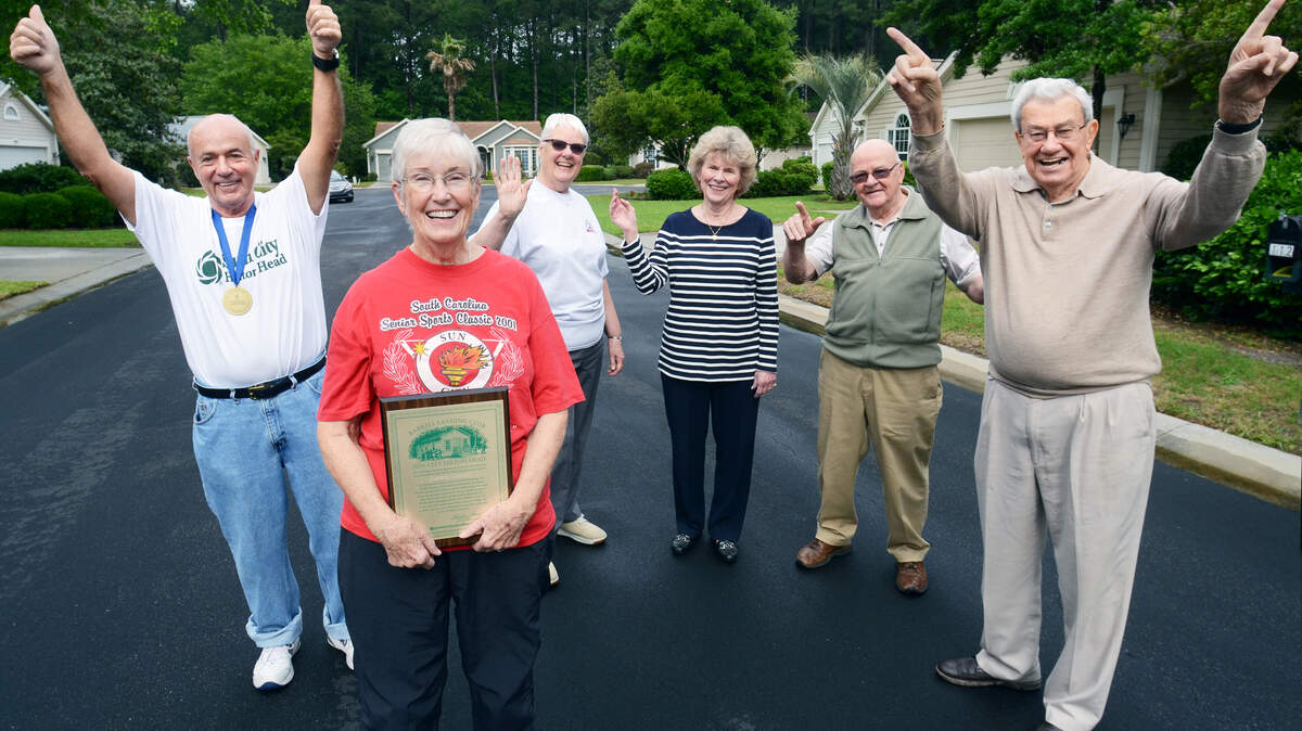 From left, Sun City Hilton Head residents Jean and Huguette Valiquette, Annette Lund, Jane Hartsig, Jack Schosser and John Iler gather Wednesday on Fort Walker Lane to celebrate 20 of years living in the age-restricted community, which opened in 1995. All six are members of the Barrel Landing Club, which means they are among the first hundred Sun City homeowners, 43 of whom still live there.