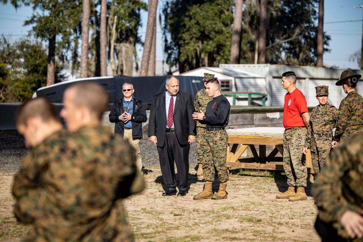 Navy Secretary Carlos Del Toro visits with a Marine at Marine Corps Recruit Depot Parris Island.