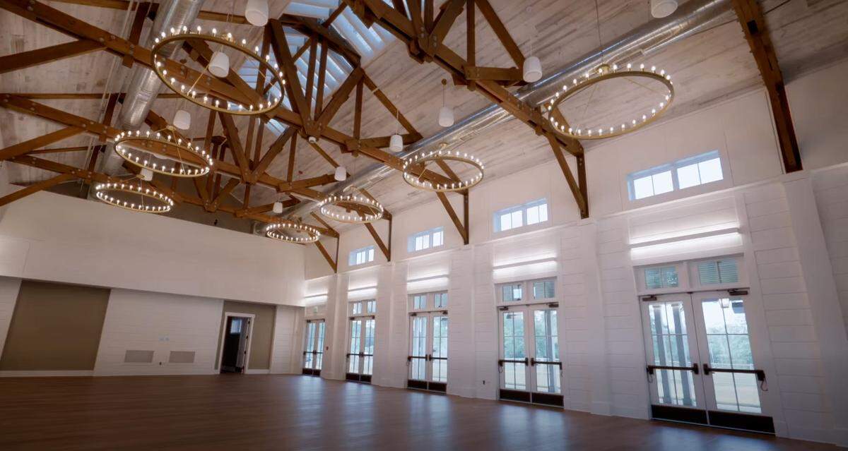 The inside of the barn features plenty of natural light and stylish chandeliers hanging form the ceiling.