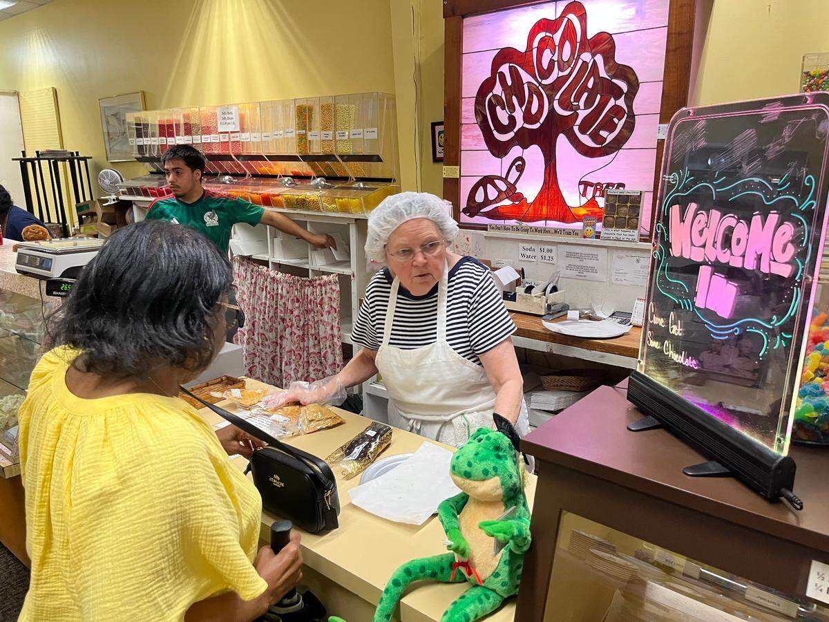 Diana Huston sells cashew brittle to Helen Brown at The Chocolate Tree in Breaufort Tuesday morning.