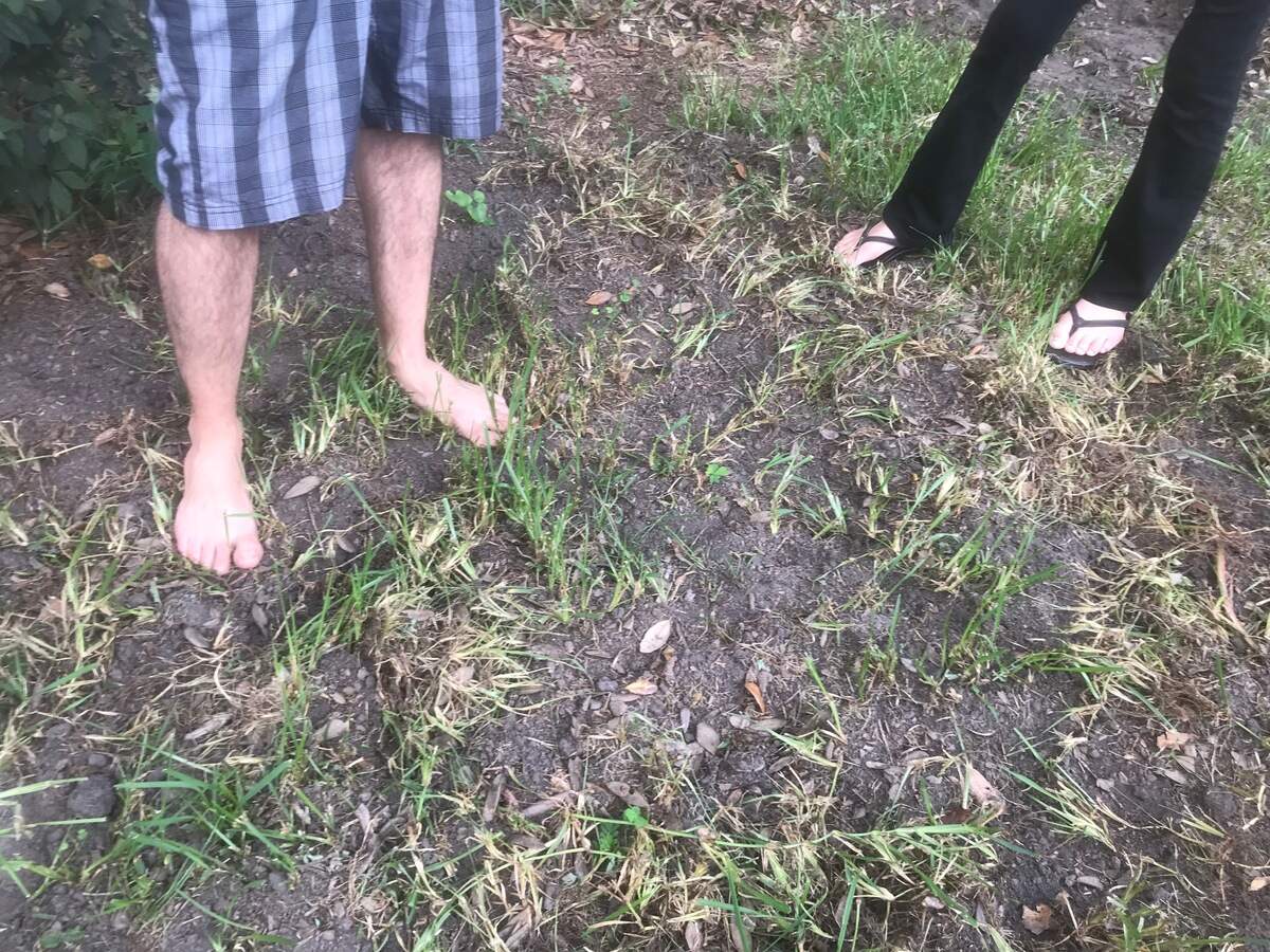 Adam Stevens and Kyla Singletary stand in their yard, which was recently rooted by pigs, on Friday, July 6, 2018, off Twin Lakes Road in Port Royal, S.C.