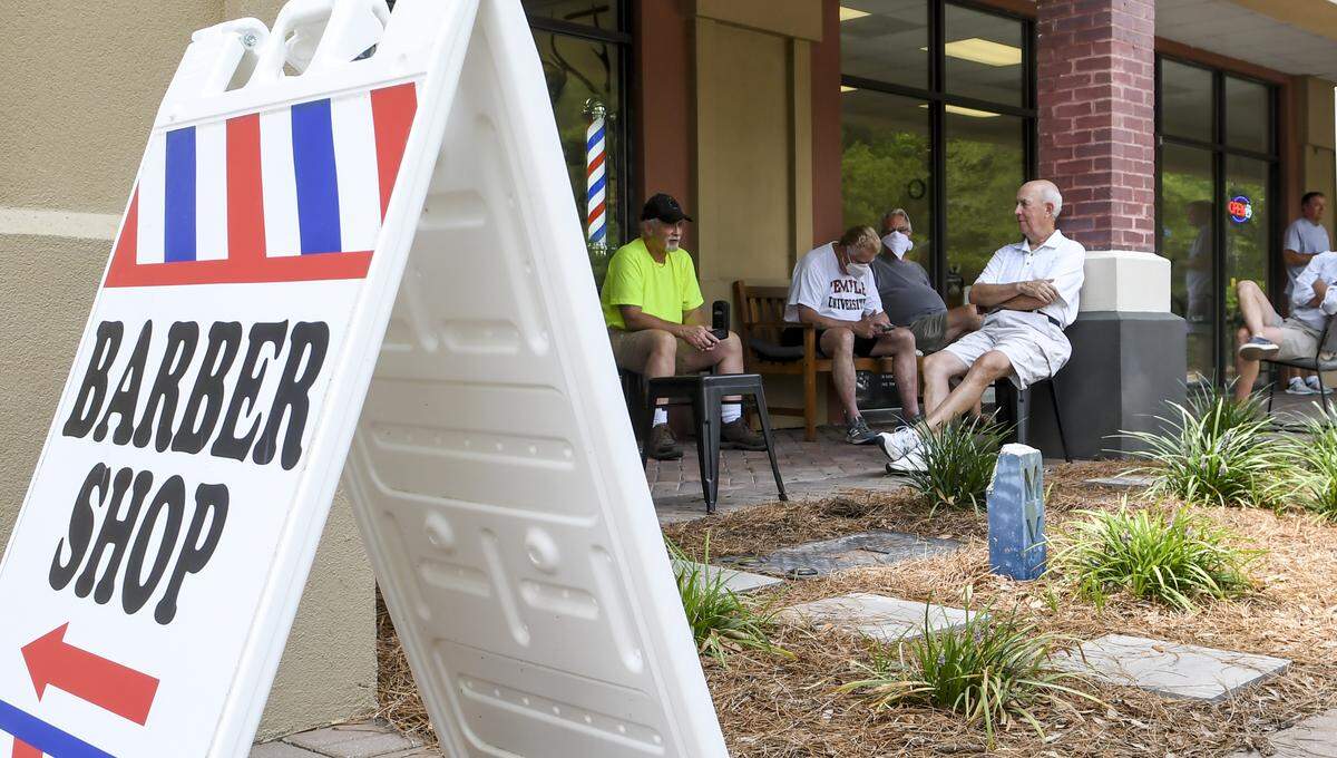 A line forms outside The Barbershop on Monday, May 18, 2020 in Bluffton’s Berkeley Place. When customers were asked how long they’ve been waiting, one person said an hour and another immediately chimed in “longer than an hour.” Monday marked the first day close-contact businesses could reopen after SC Gov. Henry McMaster’s executive order closed them on April 1, 2020.