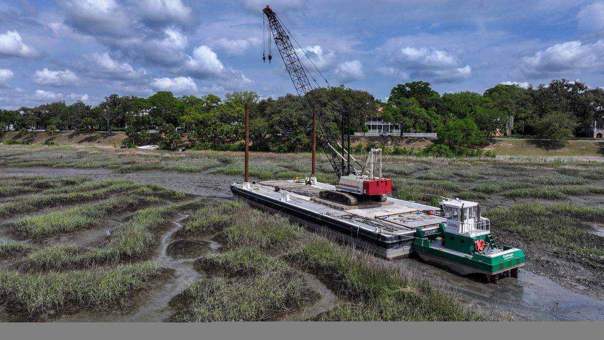 A pusher boat owned by O’Quinn Marine is ready to move a barge and crane when the tides come in on the evening of April 23, 2025 in Historic Beaufort. The crane, in tandem with the pusher boat, will remove five grounded boats that were ripped from their moorings and pushed onto the bank of the Beaufort River after Tropical Storm Helene in 2024.