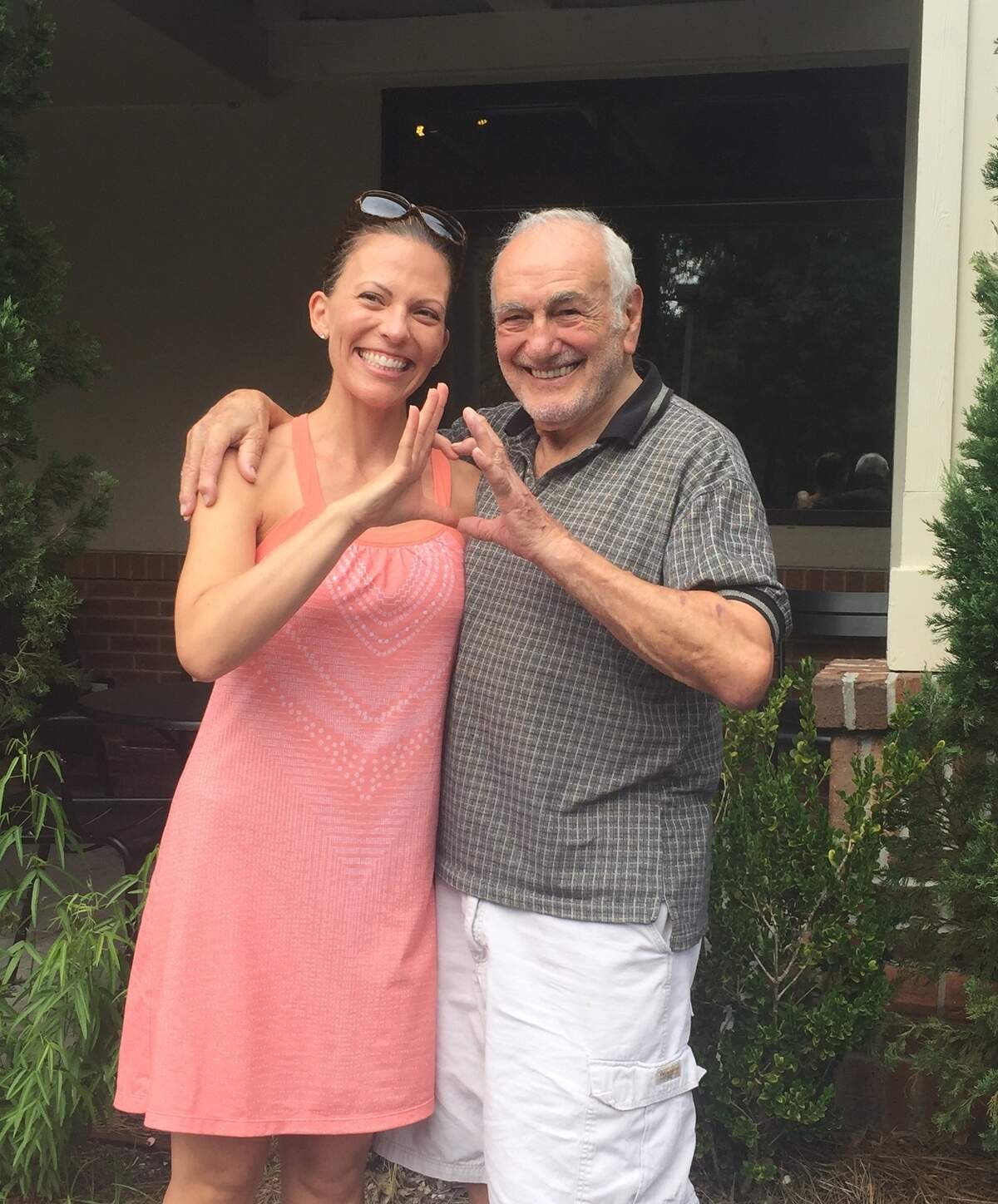 Ashley Nickelson and Tom Colasanto make a heart with their hands as they pose for a picture on Sunday, Aug. 19, 2018, on Hilton Head Island, S.C. Just over a year earlier, Nickelson, a nurse, performed CPR on Colasanto, who went into cardiac arrest on the island.